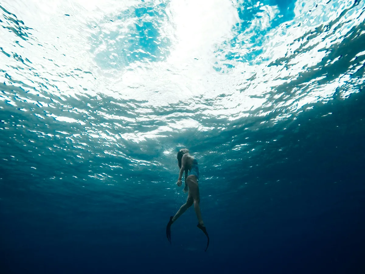 Person floating peacefully in open water