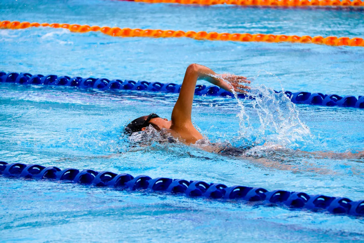 Adult doing freestyle in a swimming pool
